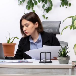 front-view-beautiful-young-businesswoman-black-jacket-blue-shirt-working-with-laptop-documents-front-table-business-job-office_140725-15858